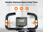 Exercise bike with digital display and heart rate monitoring features on a white background