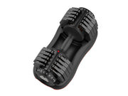 Close-up of adjustable weight dial on black and orange dumbbell for strength exercises