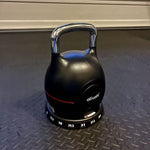 Ativafit Adjustable Kettlebell 5-44 lbs resting on gym floor with visible weight dial, designed for efficient home and gym workouts.