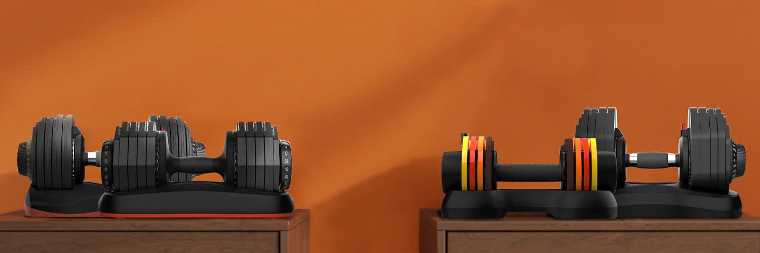 Set of adjustable dumbbells on a wooden surface with an orange background