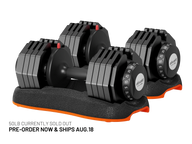 Two 50lb adjustable dumbbells in black with orange accents, displayed on a matching black and orange stand against a white background. Text at the bottom reads '50LB CURRENTLY SOLD OUT PRE-ORDER NOW & SHIPS AUG. 18