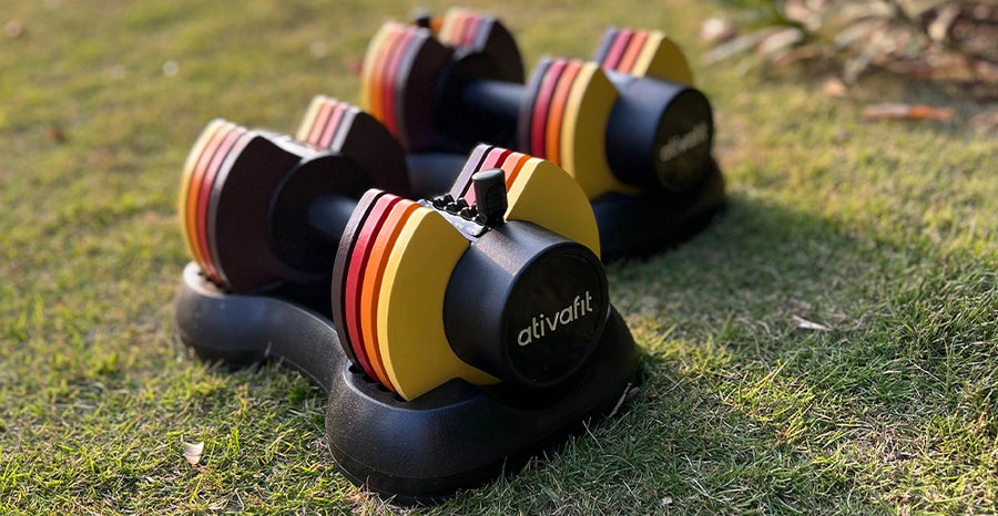 Pair of dumbbells with colorful striped design on grass