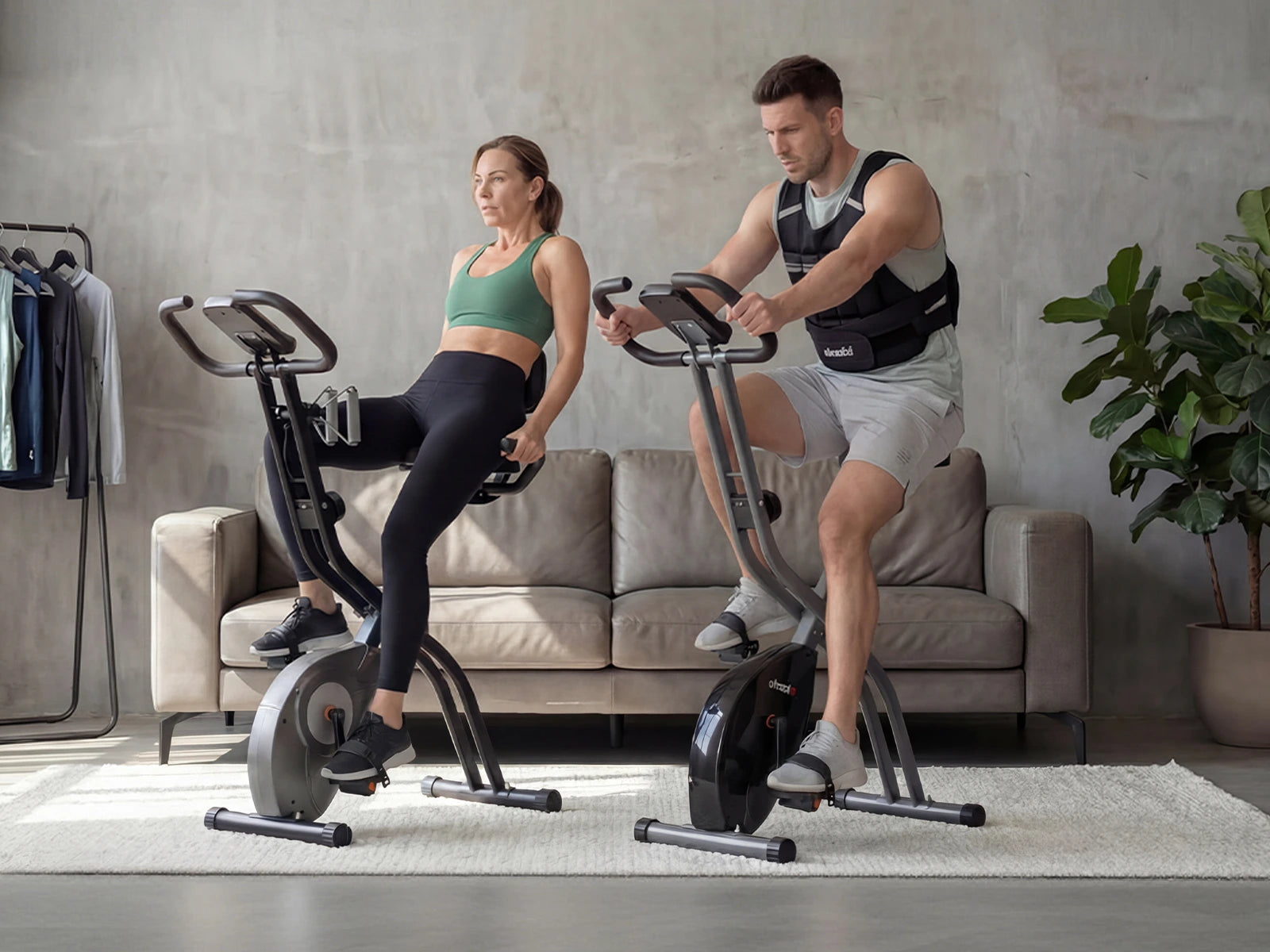 Two people exercising on stationary bikes in a home setting.