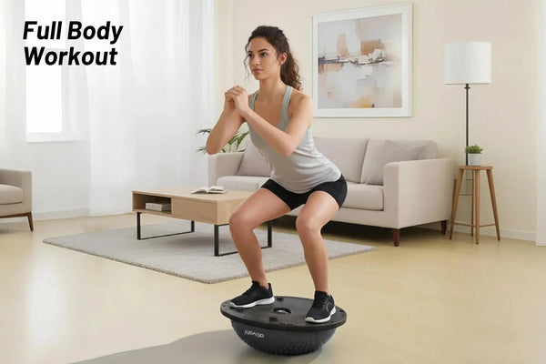 Woman exercising on a black exercise ball in a living room.
